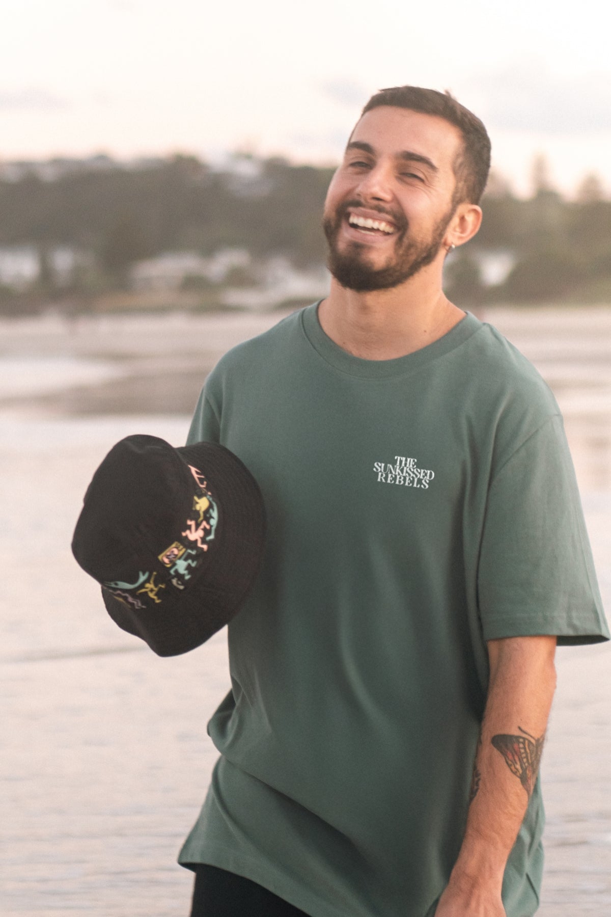 Mann lacht und trägt Vacation Mood On T-Shirt am Strand