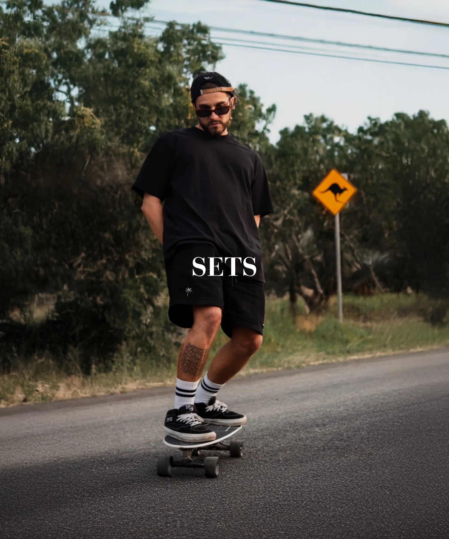 Streetwear-Set für Skateboarder in Schwarz auf urbaner Straße