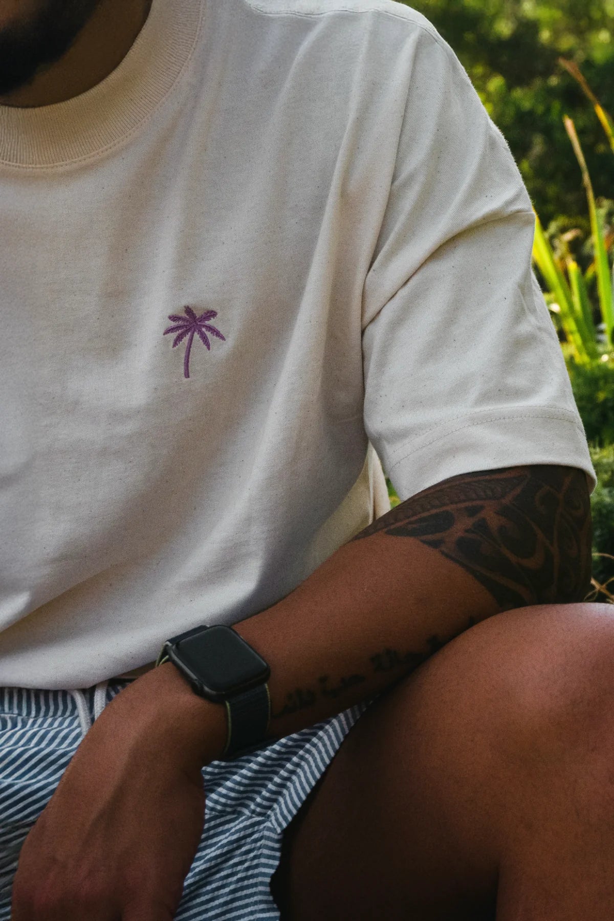 Detailansicht des Palm-Sticks auf Oversized T-Shirt mit Tätowierungen