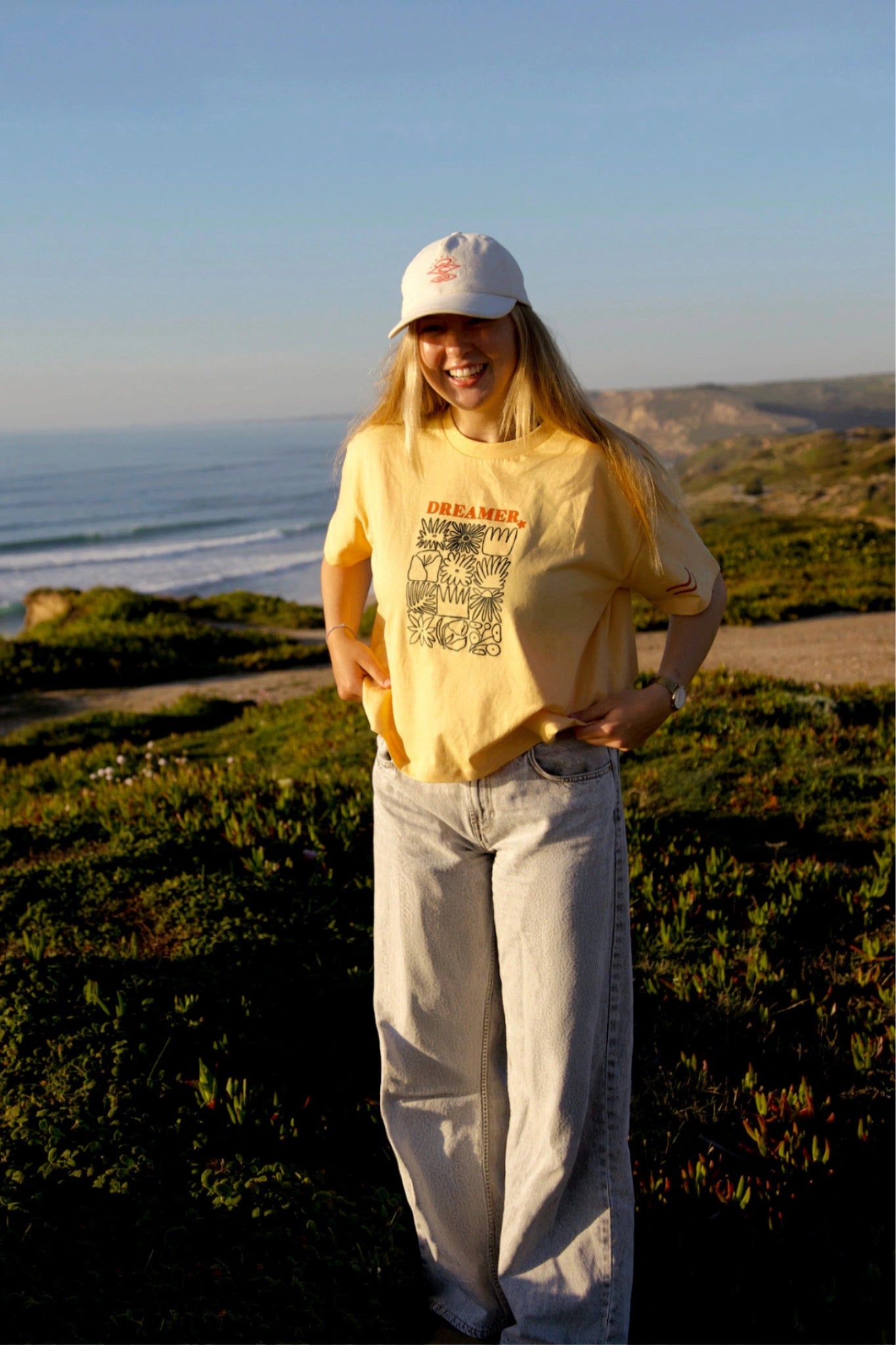 Dreamer Short T-Shirt - Papaya – Model smiling ocean view outfit
