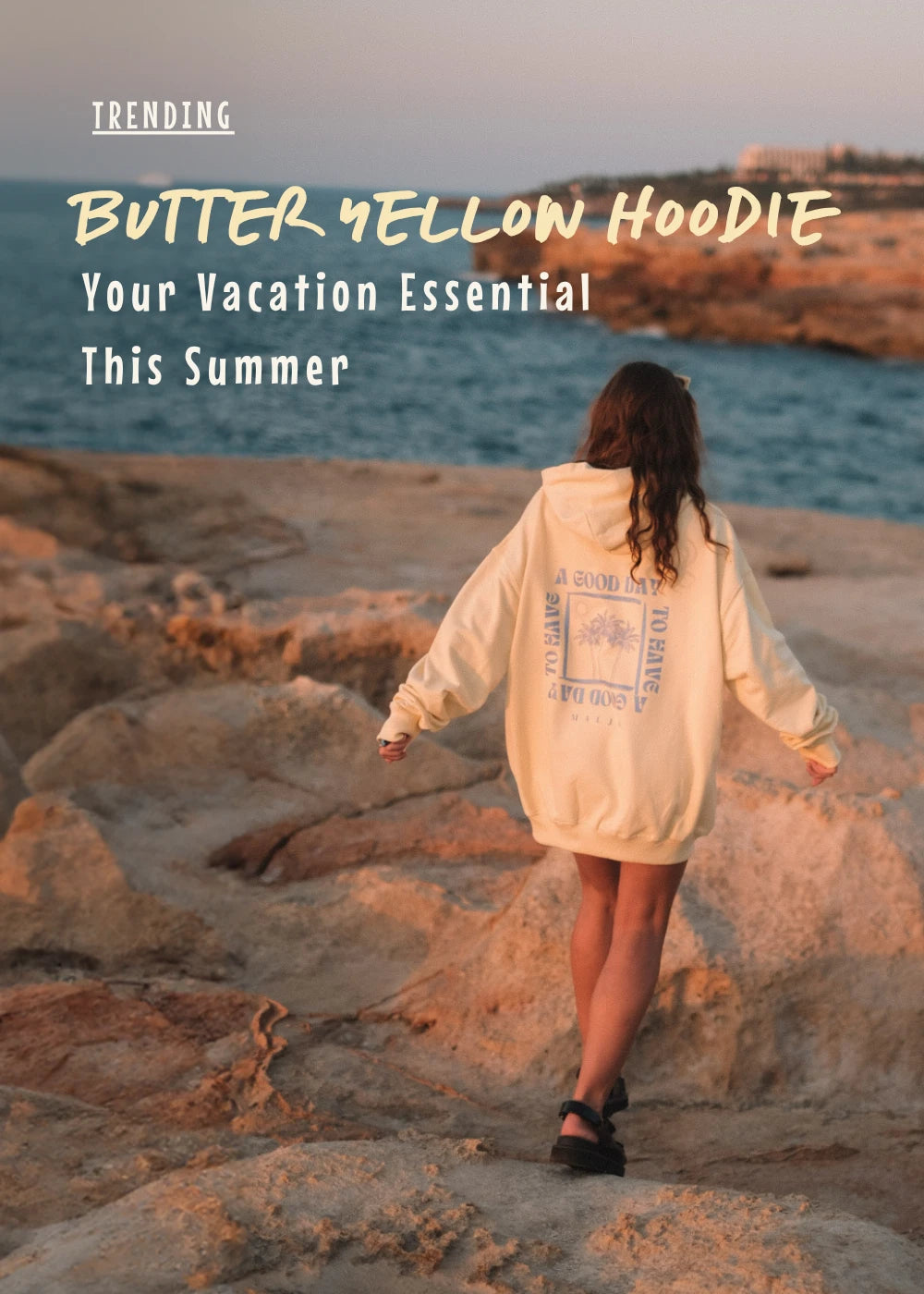 Scenic coastline at sunset with woman wearing butter yellow hoodie – trendy vacation outfit